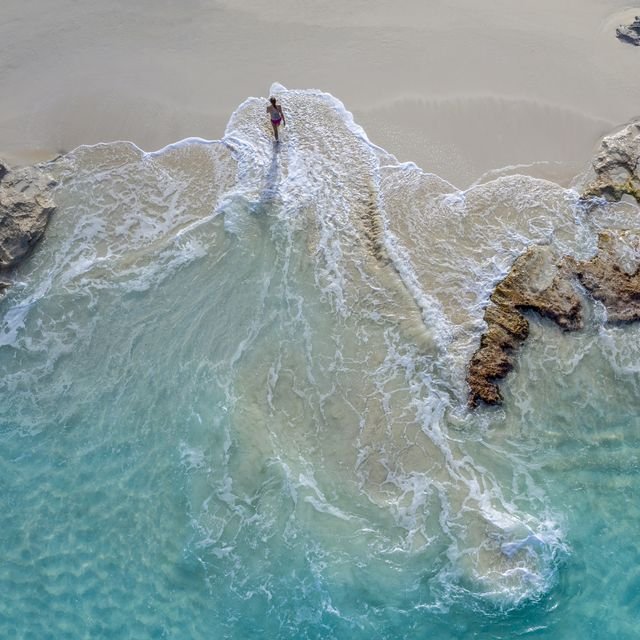 aerial-view-of-a-woman-walking-out-of-the-water-royalty-free-image-1738952336 aerial-view-of-a-woman-walking-out-of-the-water-royalty-free-image-1738952336